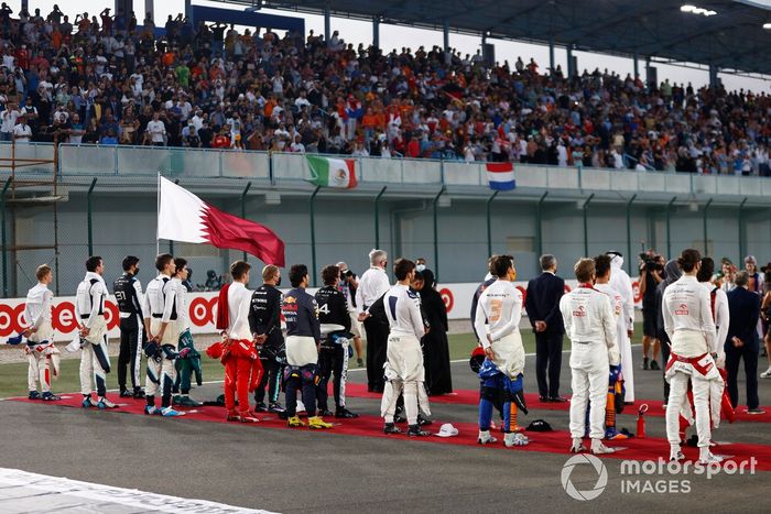 Los pilotos se colocan en la parrilla para escuchar el himno nacional antes de la salida