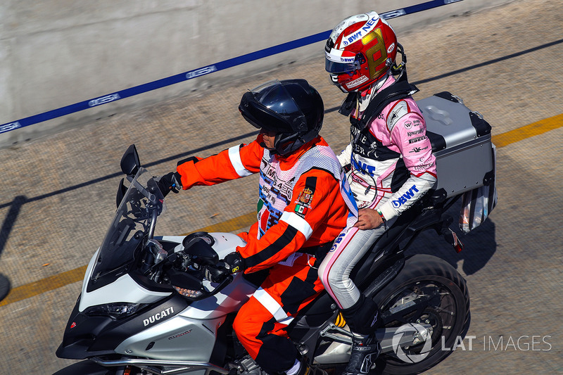 Alfonso Celis Jr., Sahara Force India gets a ride back on a motorbike with a steward after crashing in FP1