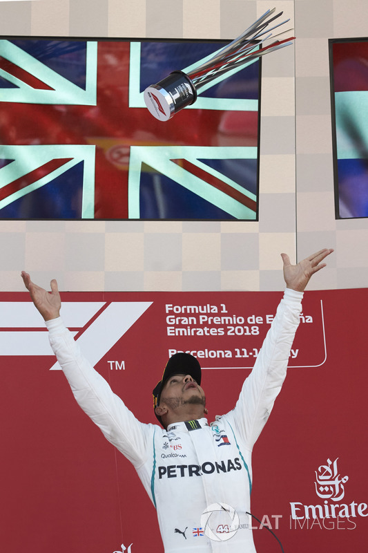 Lewis Hamilton, Mercedes AMG F1, 1st position, throws his trophy in the air in celebration