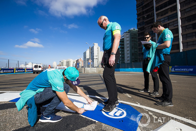 Luca Filippi, NIO Formula E Team, takes notes on a kerb
