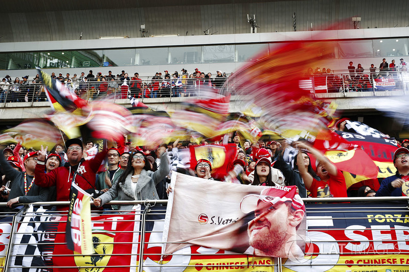 Fans of Sebastian Vettel, Ferrari, wave flags