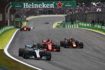 Valtteri Bottas, Mercedes AMG F1 W09, leads Sebastian Vettel, Ferrari SF71H, and a sparking Max Verstappen, Red Bull Racing RB14.