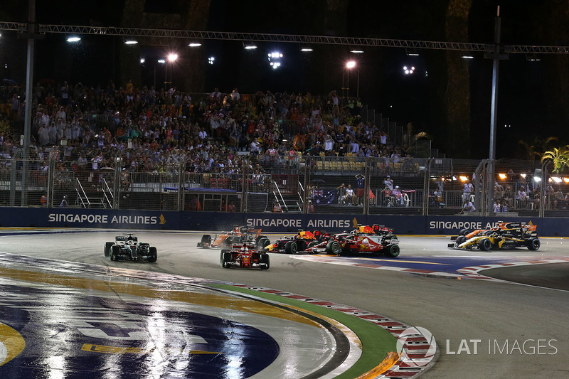 Sebastian Vettel, Ferrari SF70H leads as Max Verstappen, Red Bull Racing RB13 and Kimi Raikkonen, Fe