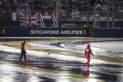 Max Verstappen, Red Bull Racing and Kimi Raikkonen, Ferrari walk on track after colliding and crashing out at the start of the race