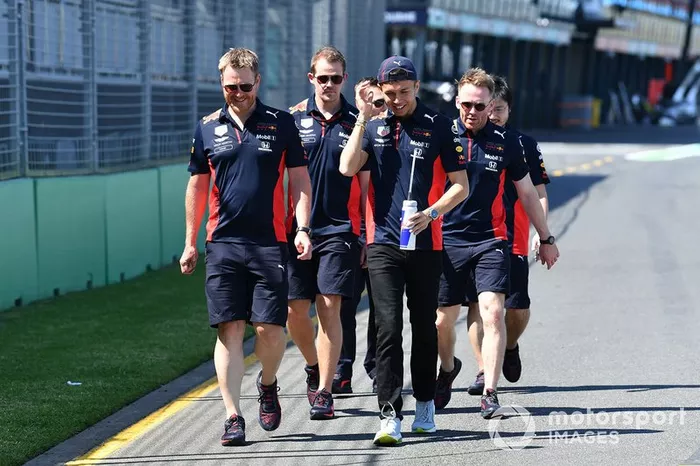 Alex Albon, Red Bull Racing walks the track with members of his team