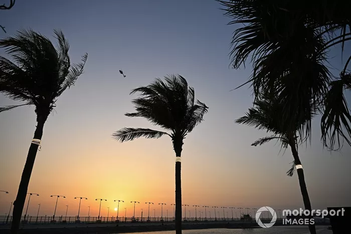 A helicopter flies over during sunset