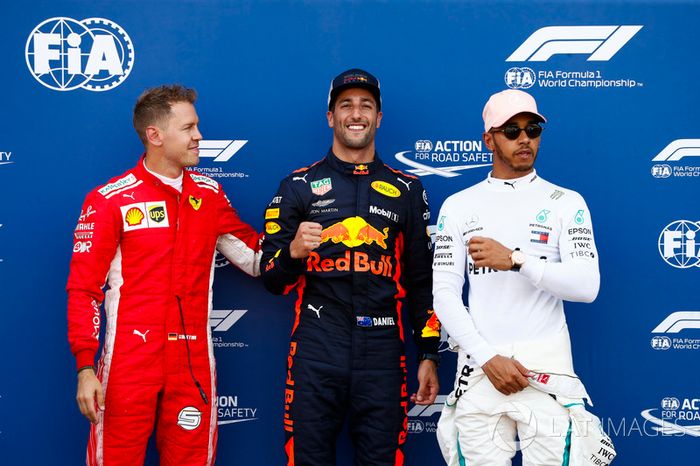 Daniel Ricciardo, Red Bull Racing, celebrates pole position between Sebastian Vettel, Ferrari, and Lewis Hamilton, Mercedes AMG F1