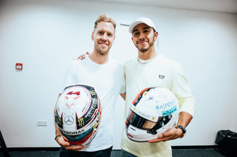 Lewis Hamilton, Mercedes AMG F1, and Sebastian Vettel, Ferrari, swap F1 helmets