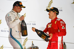 Valtteri Bottas, Mercedes AMG F1, 2nd position, and Sebastian Vettel, Ferrari, 1st position, celebrate with Waard, a non alcoholic Champagne substitute, on the podium