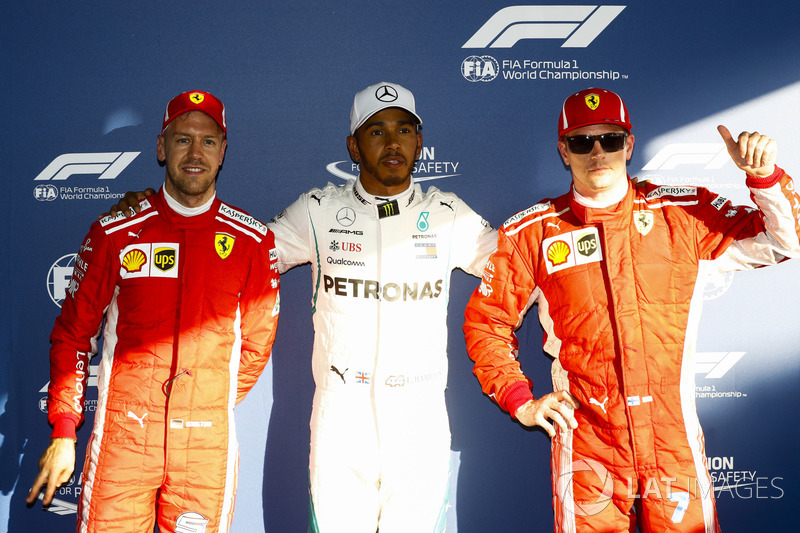 Lewis Hamilton, Mercedes AMG F1, celebrates taking pole position between Kimi Raikkonen, Ferrari, and Sebastian Vettel, Ferrari