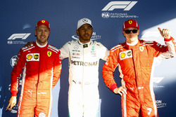 Lewis Hamilton, Mercedes AMG F1, celebrates taking pole position between Kimi Raikkonen, Ferrari, an