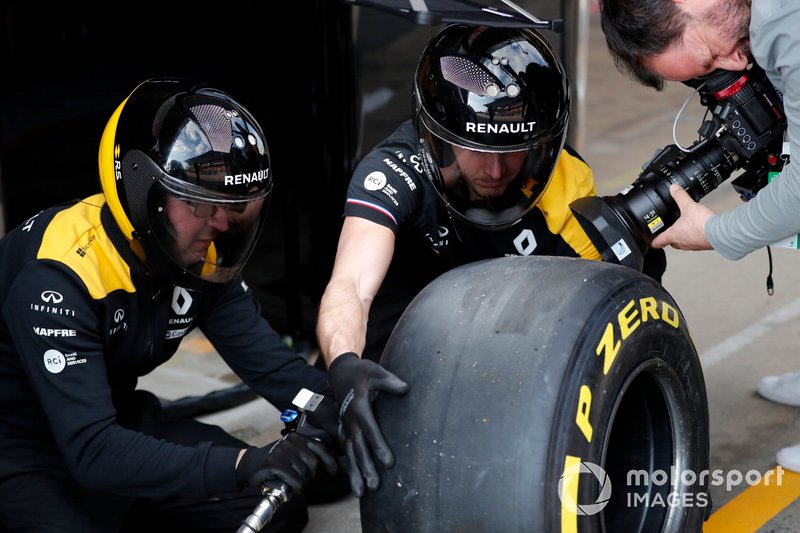 Renault F1 Team mechanics with Pirelli tyres and cameraman