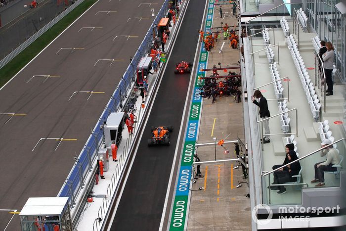 Max Verstappen, Red Bull Racing RB16B, en boxes mientras Carlos Sainz Jr., Ferrari SF21, y Daniel Ricciardo, McLaren MCL35M, pasan