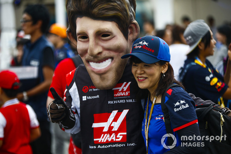 A fan gets a photo with a caricature of Romain Grosjean, Haas F1 Team