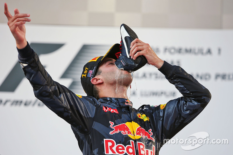 Race winner Daniel Ricciardo, Red Bull Racing celebrates on the podium by drinking champagne from hi