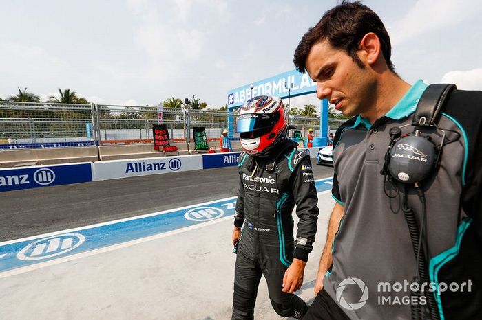Mitch Evans, Panasonic Jaguar Racing, Jaguar I-Type 3, walks with a team member.