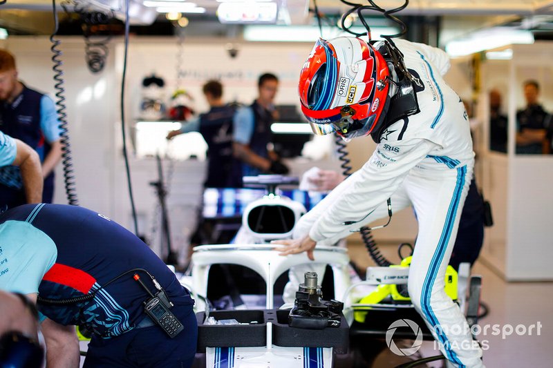 Robert Kubica, Williams Martini Racing, enters his cockpit in the team's garage