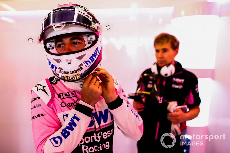 Sergio Perez, Racing Point, adjusts his helmet strap