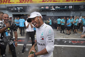 Lewis Hamilton, Mercedes AMG F1, sprays champagne in celebration of victory