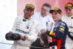Lewis Hamilton, Mercedes AMG F1, and Max Verstappen, Red Bull Racing celebrate on the podium by spraying champagne