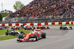 Sebastian Vettel, Ferrari SF16-H leads at the start of the race as Nico Rosberg, Mercedes AMG F1 W07 Hybrid rejoins the circuit