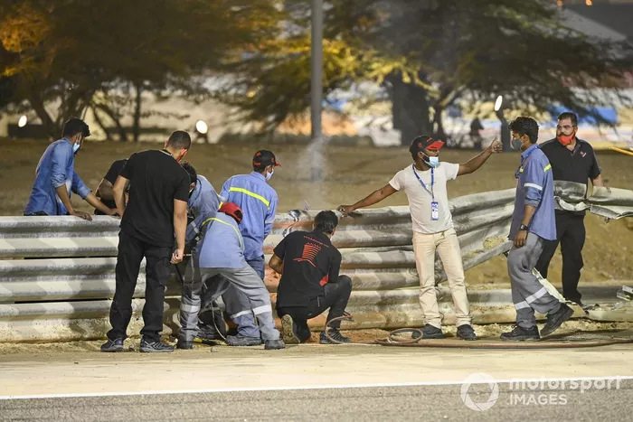 Los oficiales retiran los restos después del choque de Romain Grosjean, Haas VF-20, en la primera vuelta