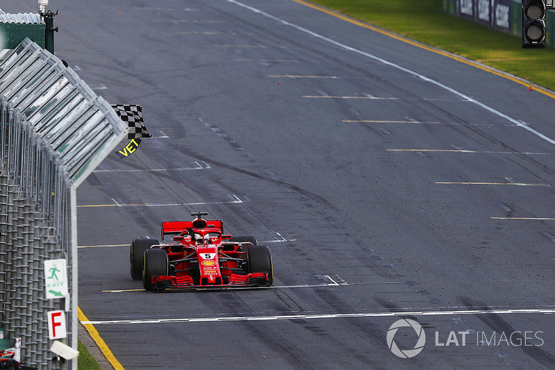 Sebastian Vettel, Ferrari SF71H, takes the chequered flag ahead of Lewis Hamilton, Mercedes AMG F1 W