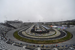 Camping World Truck Series trucks parked on pit road during a red flag for rain