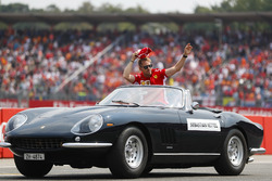Sebastian Vettel, Ferrari, waves to fans from a Ferrari 275 convertible