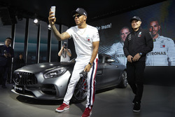 Lewis Hamilton, Mercedes AMG F1, and Valtteri Bottas, Mercedes AMG F1, on stage