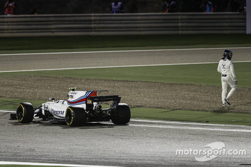 Lance Stroll, Williams FW40, climbs out of his car and walks away after a collision with Carlos Sain