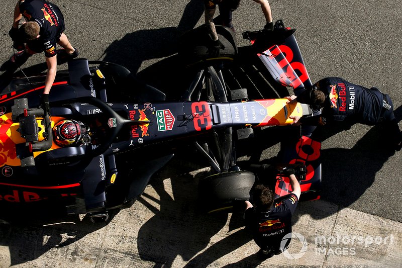 Max Verstappen, Red Bull Racing, is attended to by mechanics in the pit lane