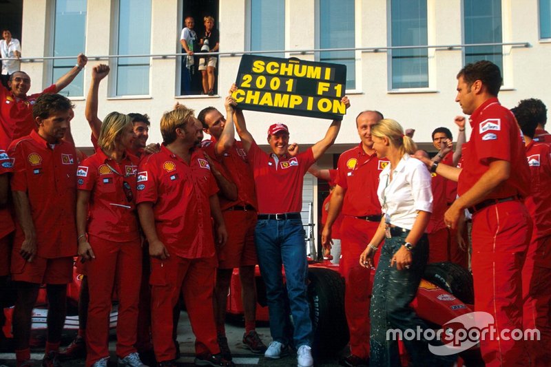 Michael Schumacher celebrates his fourth World Championship with members of the Ferrari team and his wife Corinna