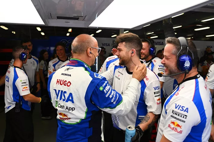 Racing Bulls team members celebrate in the garage