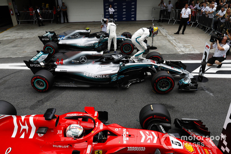 Lewis Hamilton, Mercedes AMG F1, celebrates pole position in parc ferme between Valtteri Bottas, Mercedes AMG F1 W09, and Sebastian Vettel, Ferrari SF71H.