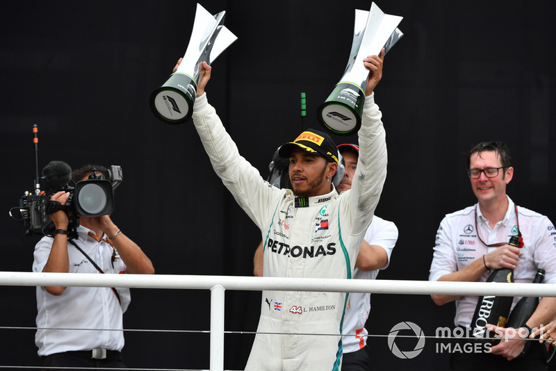 Lewis Hamilton, Mercedes AMG F1 celebrates on the podium with the trophy 