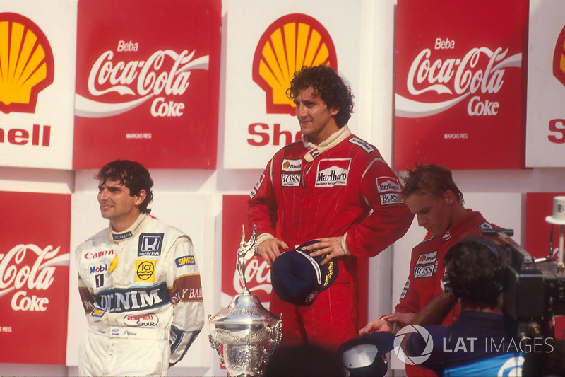 Podium: race winner Alain Prost, McLaren, second place Nelson Piquet, Williams, third place Stefan J