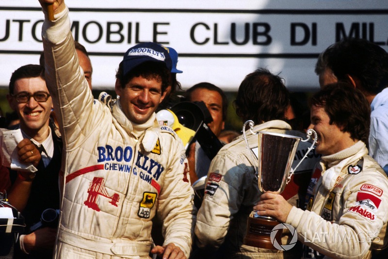 Race winner and World Championship Jody Scheckter,  celebrates on the podium with Gilles Villeneuv, Ferrari