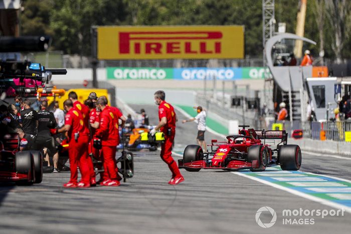 Mechanics outside the Ferrari garage as Charles Leclerc, Ferrari SF21, returns