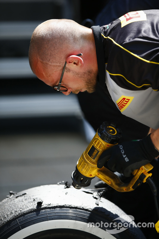 A Pirelli engineer works on some tyres