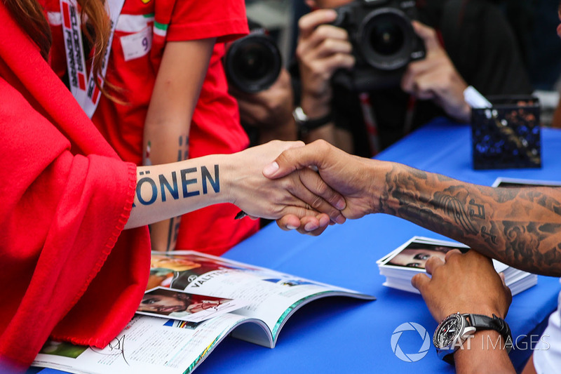 Lewis Hamilton, Mercedes AMG F1 and Kimi Raikkonen, Ferrari fan shake hands