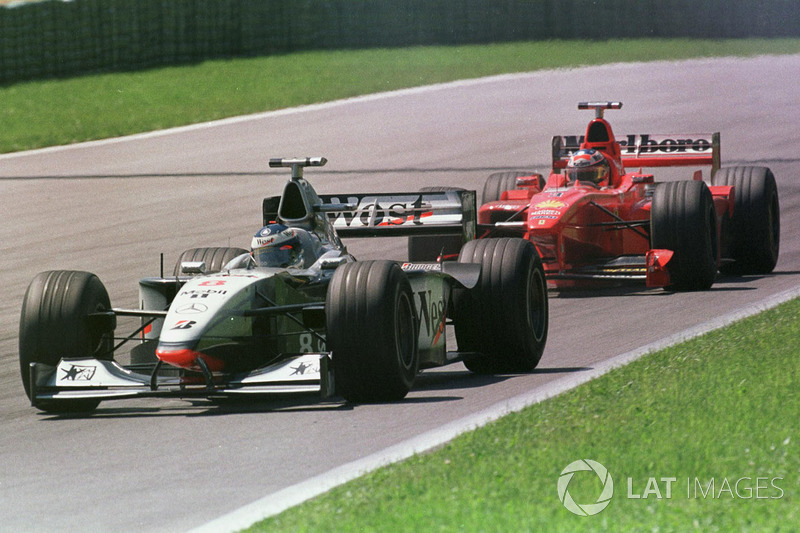 Mika Hakkinen, McLaren MP4/13 leads Michael Schumacher, Ferrari F300