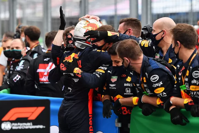 Max Verstappen, Red Bull Racing celebrates with team members in parc ferme