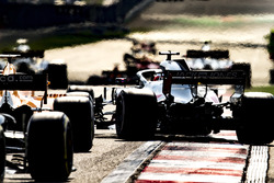 Romain Grosjean, Haas F1 Team VF-18 Ferrari, pulls across ahead of Fernando Alonso, McLaren MCL33 Renault