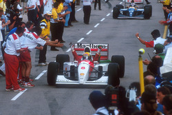 Ayrton Senna, McLaren celebrates 1st position on the way down the pit lane to parc ferme