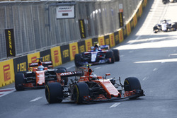 Stoffel Vandoorne, McLaren MCL32, leads Fernando Alonso, McLaren MCL32, and Carlos Sainz Jr., Scuder
