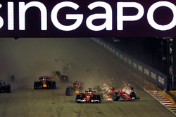 Sebastian Vettel, Ferrari SF70H leads at the start of the race and the cars of Kimi Raikkonen, Ferrari SF70H and Max Verstappen, Red Bull Racing RB13 crash after colliding