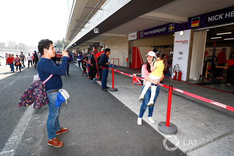 Fans pose for a photo in the pitlane,