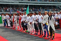 The drivers as the grid observes the national anthem