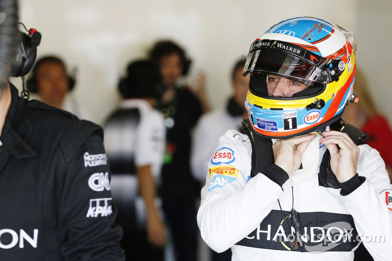 Fernando Alonso, McLaren MP4-31 adjusts his helmet in the garage